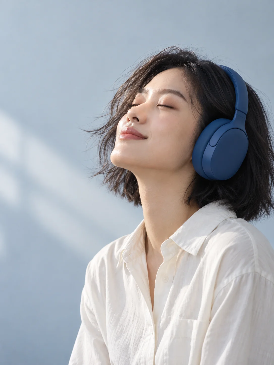 A listener wearing blue headphones in the concept campaign